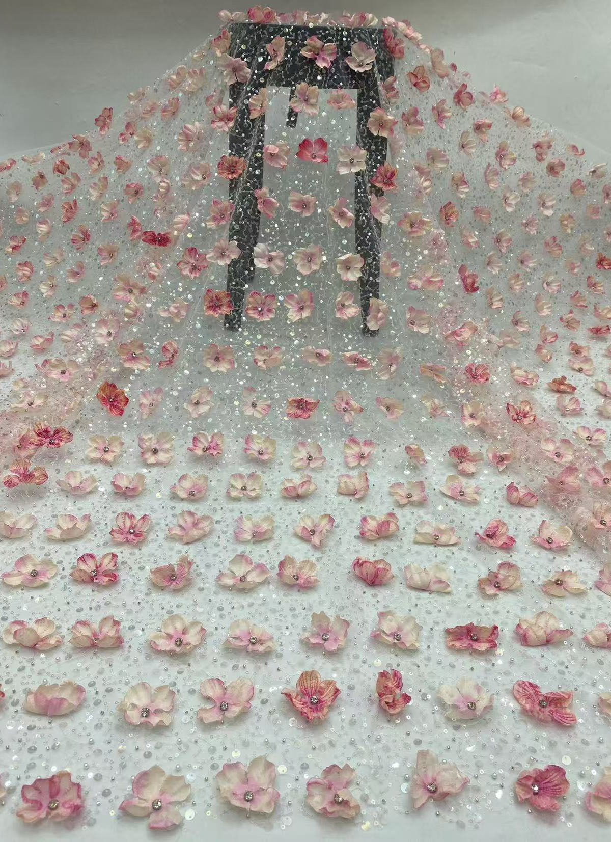 New hand-embroidered floral designs with beads and sequins, elegant women's evening dresses, blouses, strapless gowns, and bead-embellished fabric.